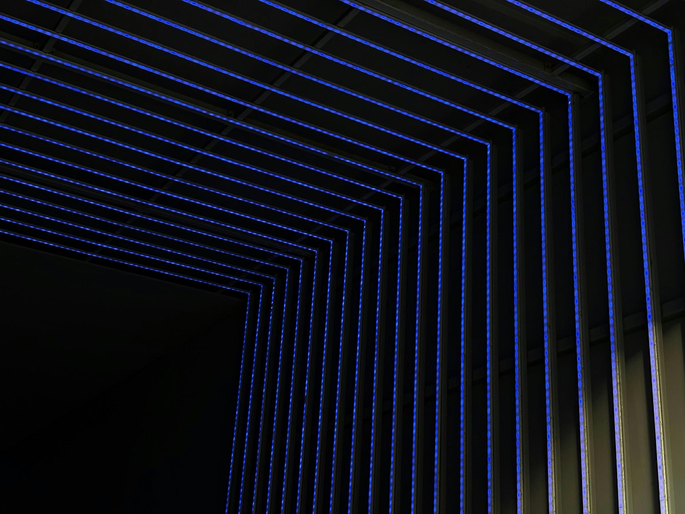 Repeating architectural frames illuminated by electric-blue light